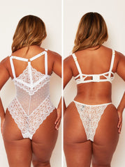 White lace lingerie set worn by a model on a plain background