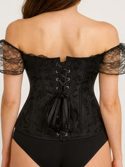 Black lace corset worn by a model on a plain background