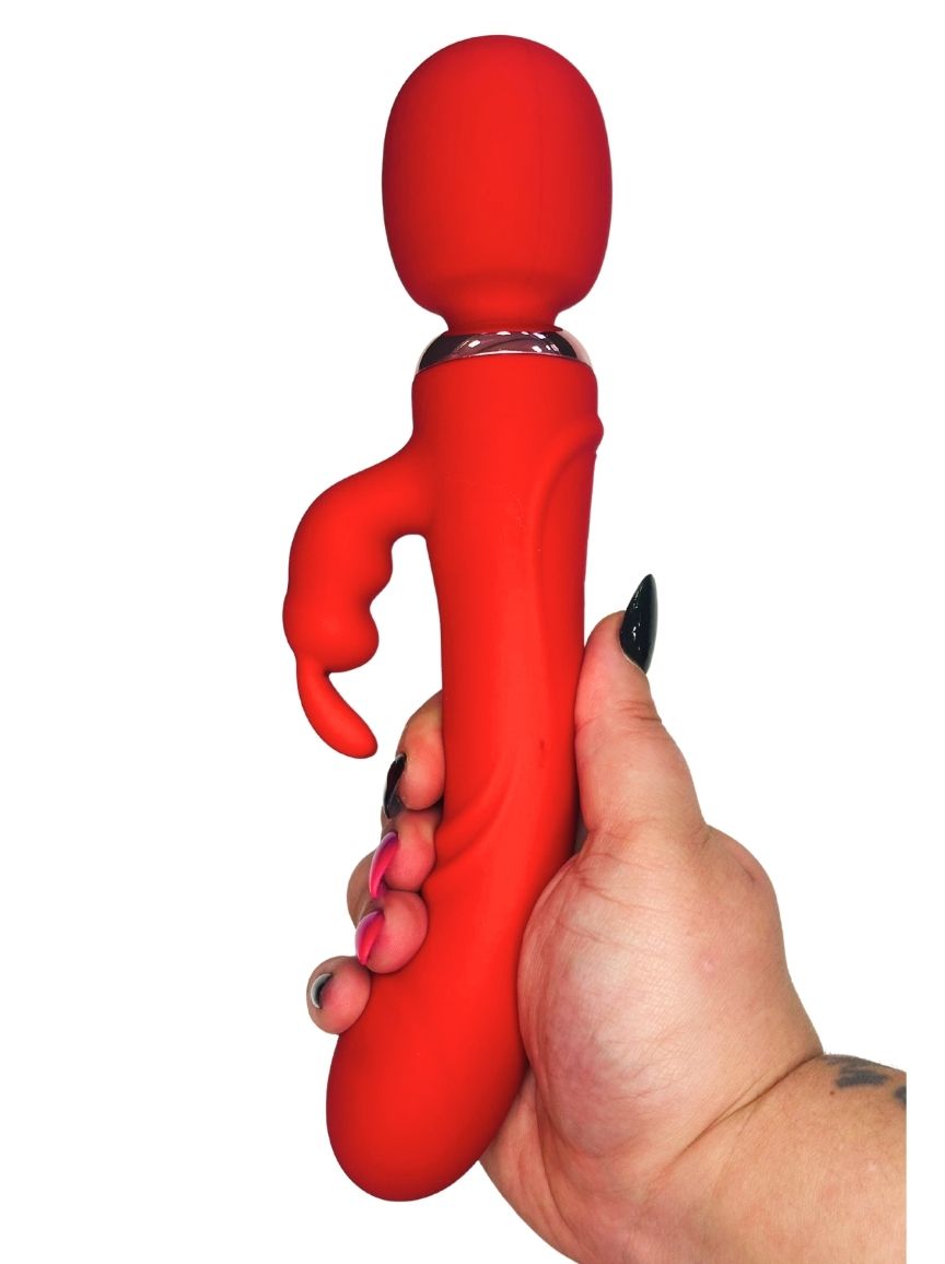 Red silicone toy held by a hand on a white background