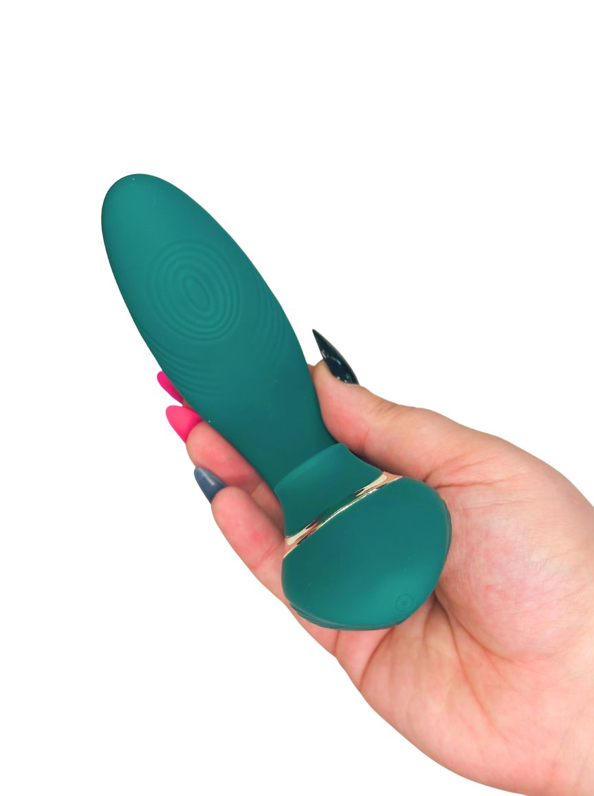 green personal massager adult toy in hand on white background
