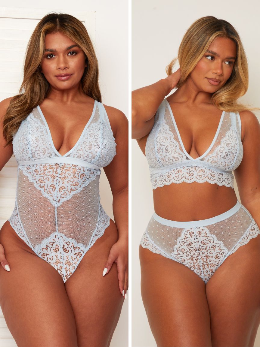 Woman wearing a white lace lingerie set against a plain background